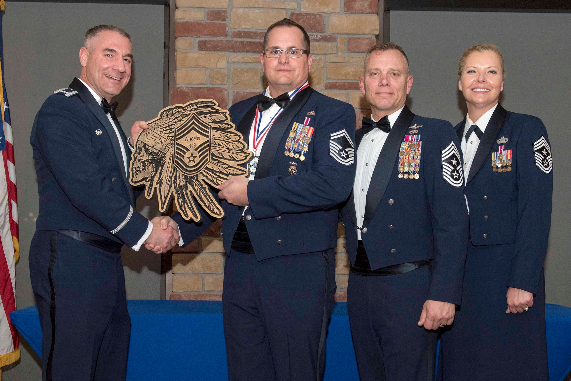 Senior Master Sgt. Max Wheeler, 49th Civil Engineer Squadron deputy fire chief, accepts a plaque during the Chief Recognition Ceremony, Feb. 15, 2020, on Holloman Air Force Base, N.M. Eight individuals from Team Holloman were recognized during the formal ceremony and dinner. (U.S. Air Force photo by Staff Sgt. Christine Groening)