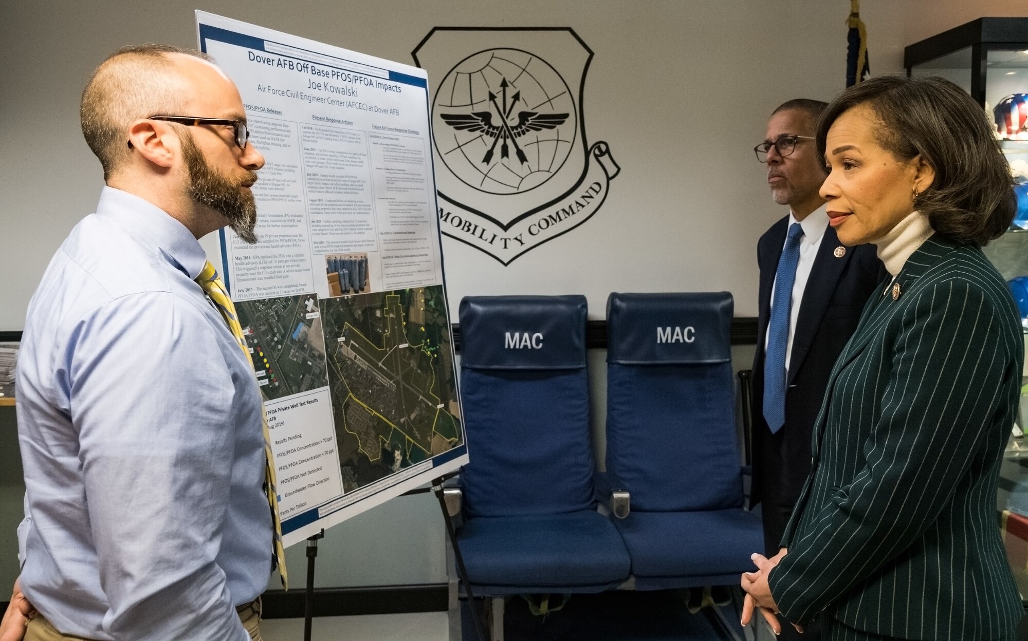 Joe Kowalski, Air Force Civil Engineer Center remedial project manager, briefs Rep. Lisa Blunt Rochester of Delaware and Rep. Anthony Brown of Maryland at the Isochronal Inspection Dock, Feb. 14, 2020, on Dover Air Force Base, Delaware. Kowalski briefed the representatives on the status of perfluorooctanoic acid and perfluorooctane sulfonate monitoring on and around Dover AFB. (U.S. Air Force photo by Roland Balik)