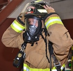 firefighter putting on helment