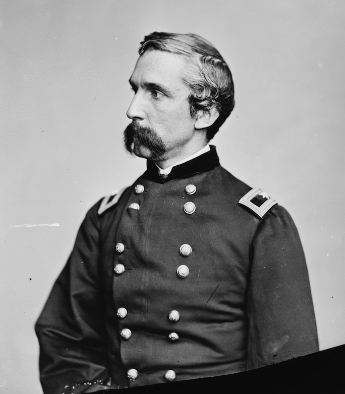 A man with a large mustache in Civil War dress uniform poses while looking into the distance.