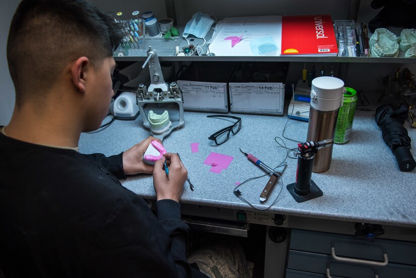 Airman works at the dental laboratory.