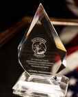 A stylized photo of the 2019 Air National Guard, Director of Safety Award for Outstanding Achievement in Occupational Safety. The award is crystal with the title of the award, etched on the surface.