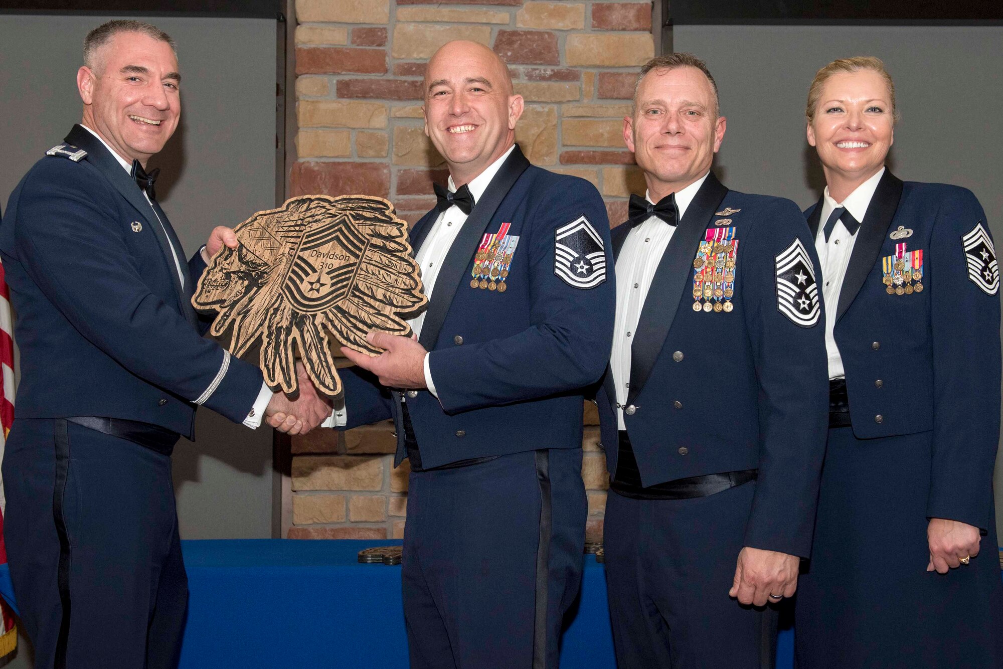 Senior Master Sgt. Jacob Davidson, 492nd Attack Squadron superintendent, accepts a plaque during the Chief Recognition Ceremony, Feb. 15, 2020, on Holloman Air Force Base, N.M. Eight individuals from Team Holloman were recognized during the formal ceremony and dinner. (U.S. Air Force photo by Staff Sgt. Christine Groening)