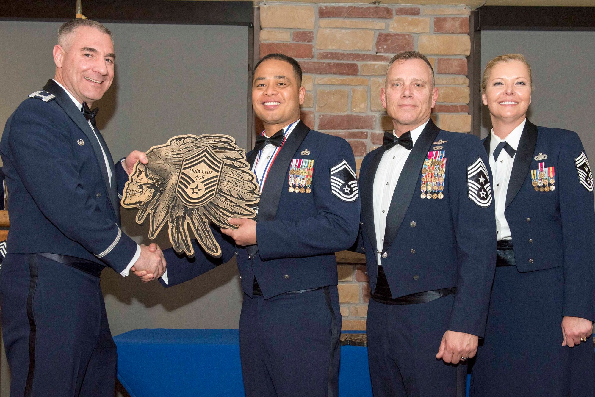 Senior Master Sgt. Jayar Dela Cruz, 49th Civil Engineer Squadron operations flight superintendent, accepts a plaque during the Chief Recognition Ceremony, Feb. 15, 2020, on Holloman Air Force Base, N.M. Eight individuals from Team Holloman were recognized during the formal ceremony and dinner. (U.S. Air Force photo by Staff Sgt. Christine Groening)