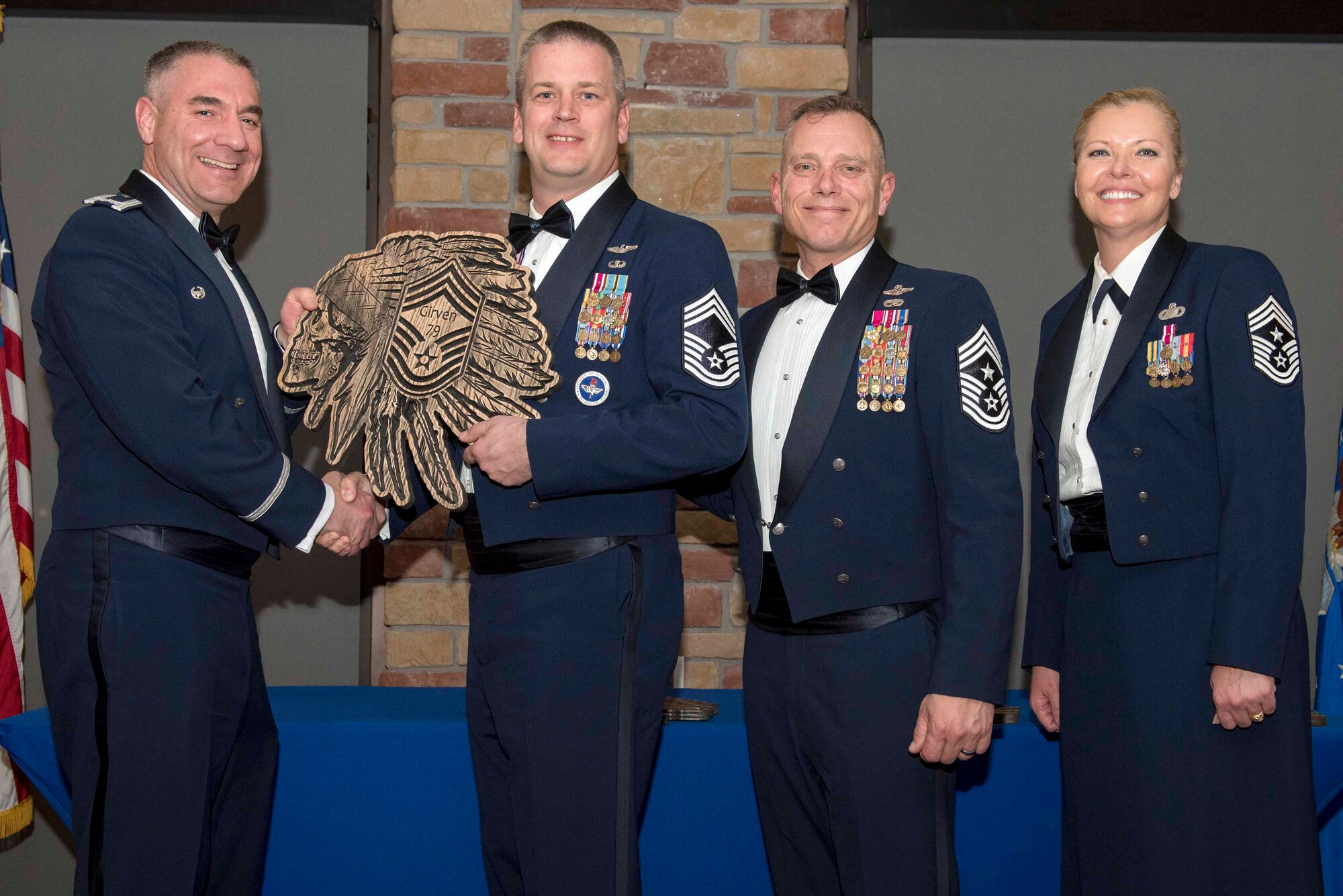 Chief Master Sgt. Westly Girven, 29th Attack Squadron superintendent, accepts a plaque during the Chief Recognition Ceremony, Feb. 15, 2020, on Holloman Air Force Base, N.M. Eight individuals from Team Holloman were recognized during the formal ceremony and dinner. (U.S. Air Force photo by Staff Sgt. Christine Groening)