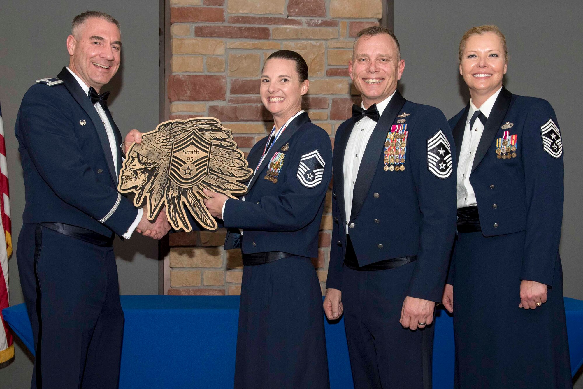 Senior Master Sgt. Amy Smith, 49th Aircraft Communications Maintenance Unit flight chief, accepts a plaque during the Chief Recognition Ceremony, Feb. 15, 2020, on Holloman Air Force Base, N.M. Eight individuals from Team Holloman were recognized during the formal ceremony and dinner. (U.S. Air Force photo by Staff Sgt. Christine Groening)