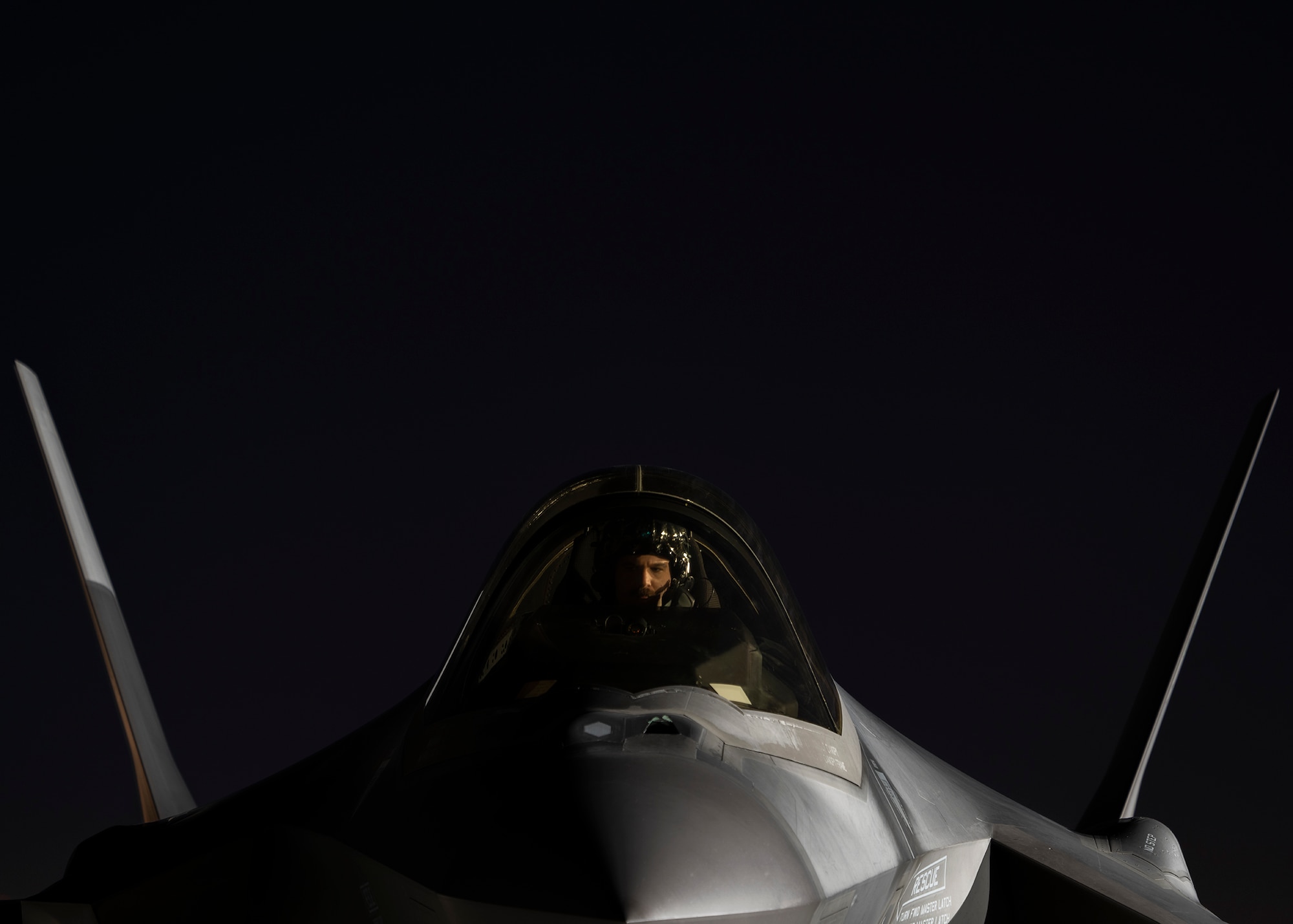 An F-35A Lightning II fighter jet pilot sits in the cockpit of an F-35A.