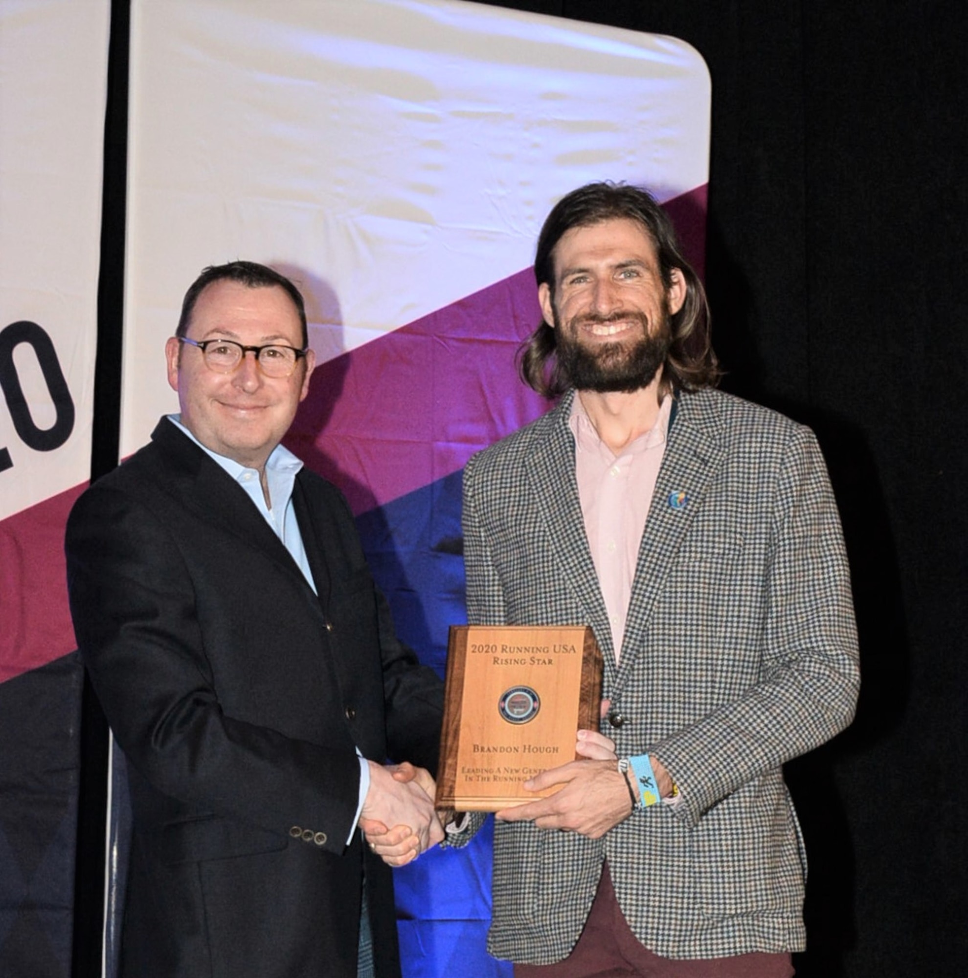 Left to right, CEO of Running USA, Rich Harshbarger, presents Air Force Marathon director, Brandon Hough, the Rising Star award at the Running USA Industry Conference in Las Vegas, Feb. 9, 2020. (Courtesy photo)