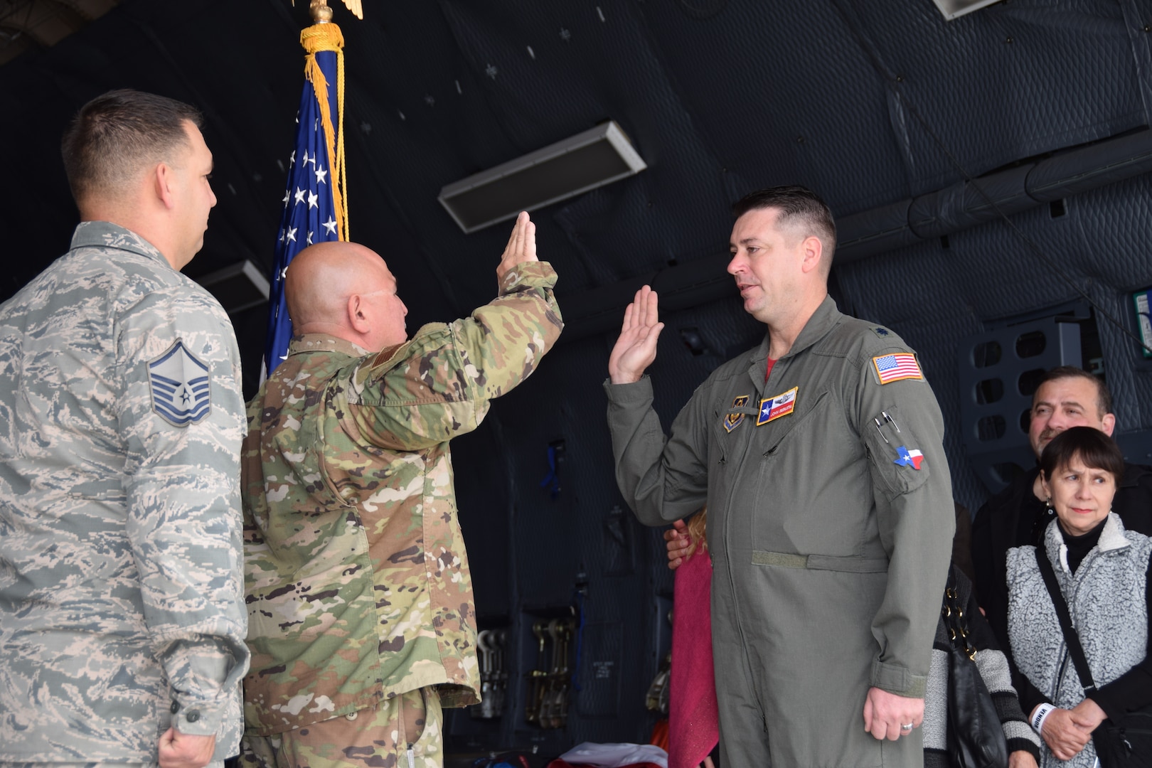 Lt. Col. John E. Sebesta, 68th Airlift Squadron C-5 pilot, administers the reenlistment oath to Tech. Sgt. Jorge Aradillas, 433rd Aircraft Maintenance Squadron ground equipment technician at Joint Base San Antonio Lackland, Texas in a C-5M Super Galaxy Feb. 15, 2020, at the Stars and Stripes Air Show in Laredo, Texas. (U.S. Air Force photo by Tech. Sgt. Iram Carmona)