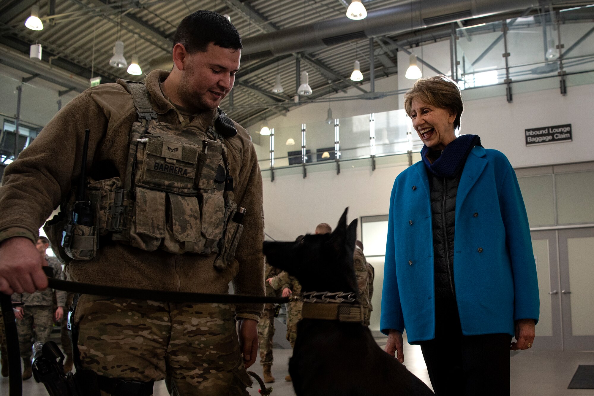 Secretary of the Air Force Barbara M. Barrett meets U.S. Air Force Senior Airman Erik Barrera, 52nd Security Forces Squadron military working dog handler, and Ccatilina, an MWD, in the passenger terminal at Spangdahlem Air Base, Germany, Feb. 15, 2020. Barrett visited base for a short tour, refuel, and to meet and thank on-duty Airmen over the weekend. (U.S. Air Force photo by Airman 1st Class Valerie Seelye)