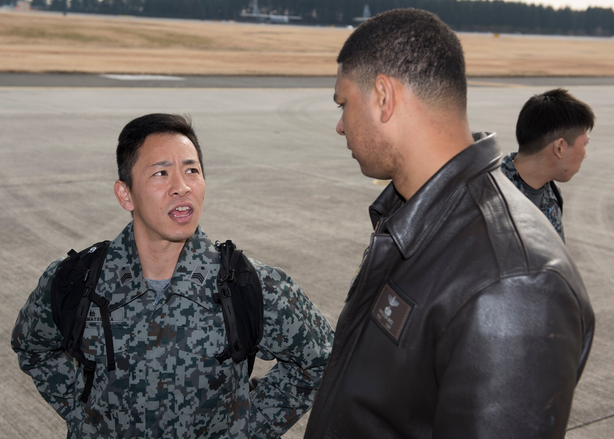A member of the Japan Air Self-Defense Force talks with Master Sgt. Napoleon Ortiz, 374th Operations Group group evaluator loadmaster, during a tour of a C-130J Super Hercules at Yokota Air Base, Japan, Feb.12, 2020.