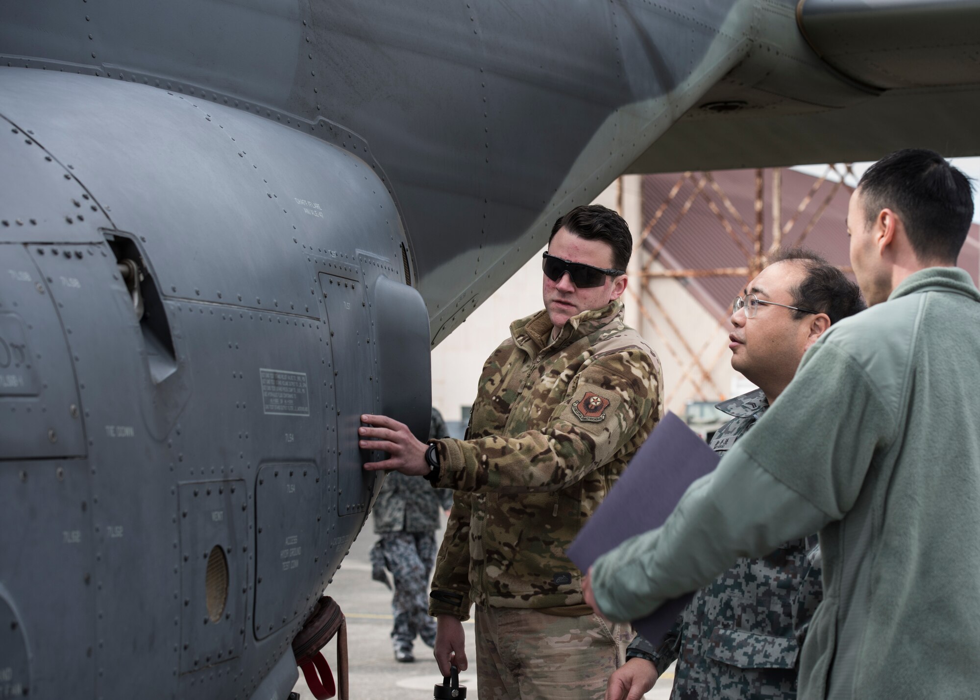 Tech. Sgt. Daniel Moxley, 753th Special Operations Aircraft Maintenance Squadron crew chief, answers a question from a Japan Air Self-Defense Force member during a tour of CV-22 Osprey, at Yokota Air Base, Japan, Feb.12, 2020.