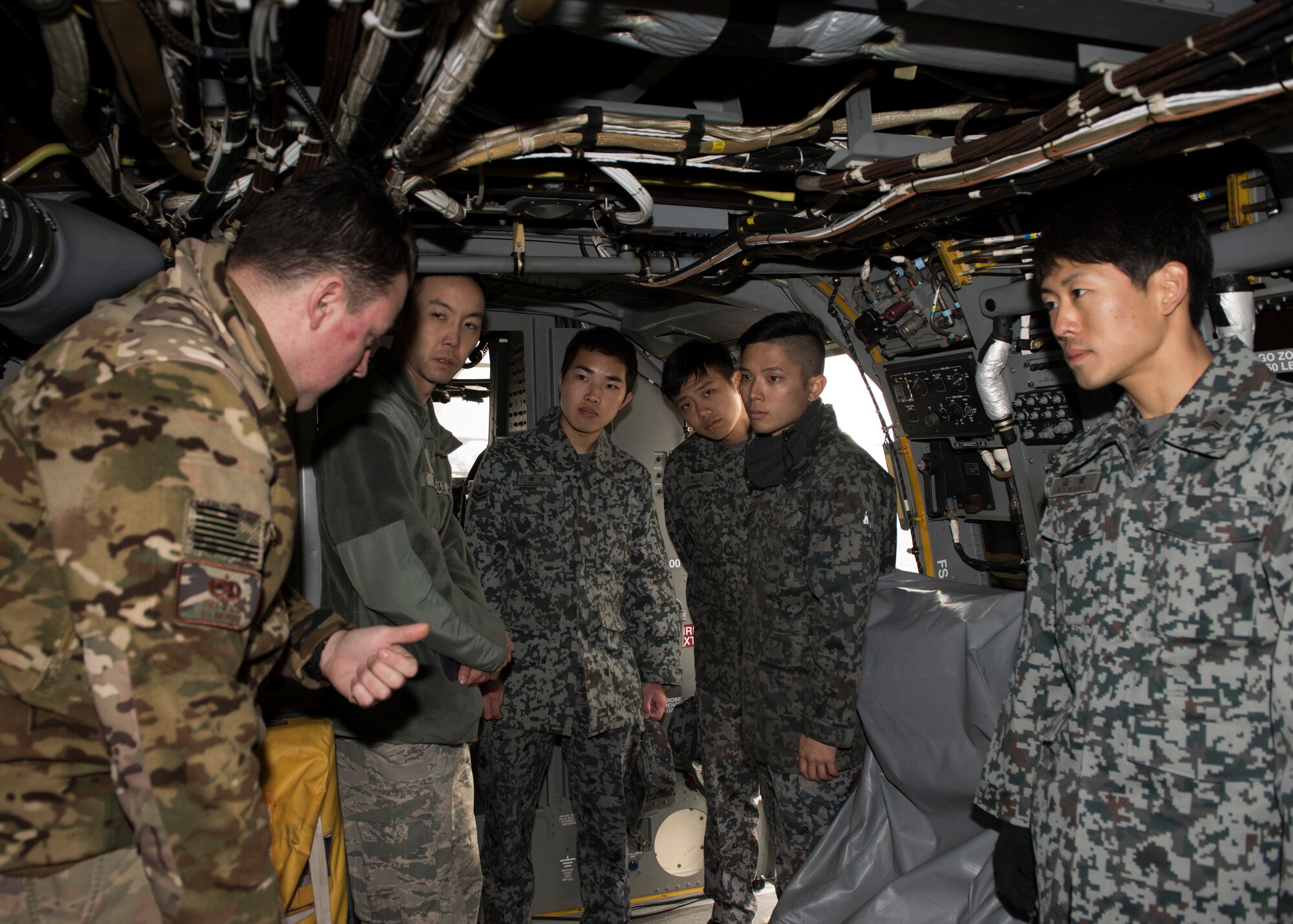 Tech. Sgt. Daniel Moxley, 753th Special Operations Aircraft Maintenance Squadron crew chief, gives a CV-22 Osprey brief to Japan Air Self-Defense Force members, assigned to the Iruma Air Base, during a tour at Yokota Air Base, Japan, Feb.12, 2020.
