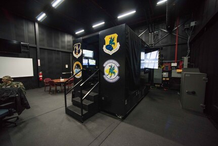 The 166th Airlift Wing C-130H2 flight simulator in its dedicated, climate controlled building, Dec. 12, 2019. The sim building also functions as a classroom and has whiteboards, presentation A/V equipment and a conference table for crew training.