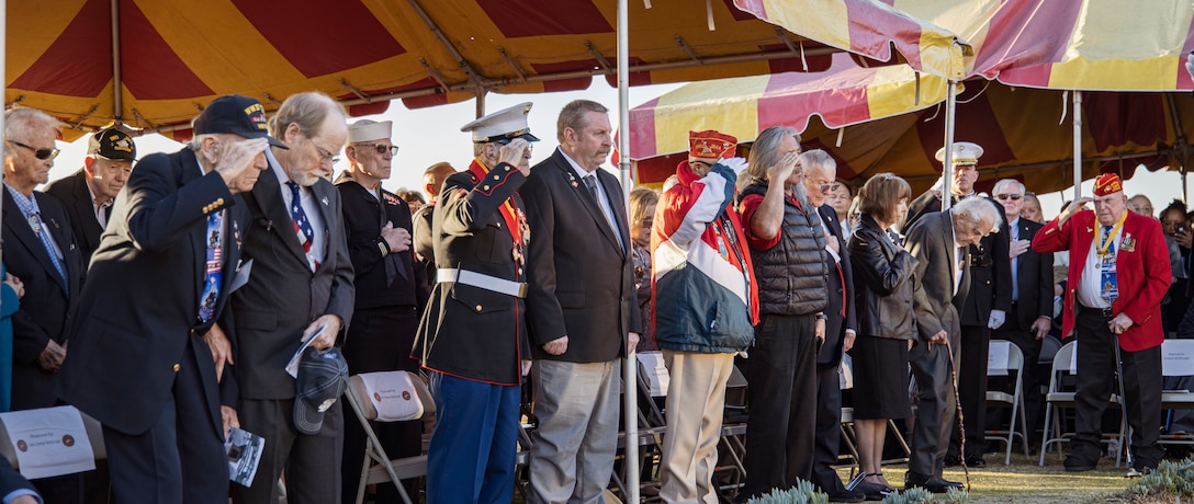 Iwo Jima veterans, along with more than 100 others in attendance, stand and salute during the national anthem at the 75th Commemoration of the Battle of Iwo Jima sunset ceremony at Marine Corps Base Camp Pendleton, California, Feb. 15.