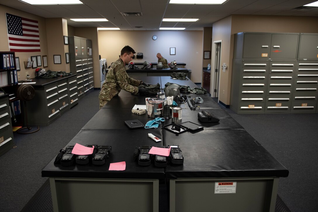 A photo of an Airman preparing an Anti-G suit during an inspection.