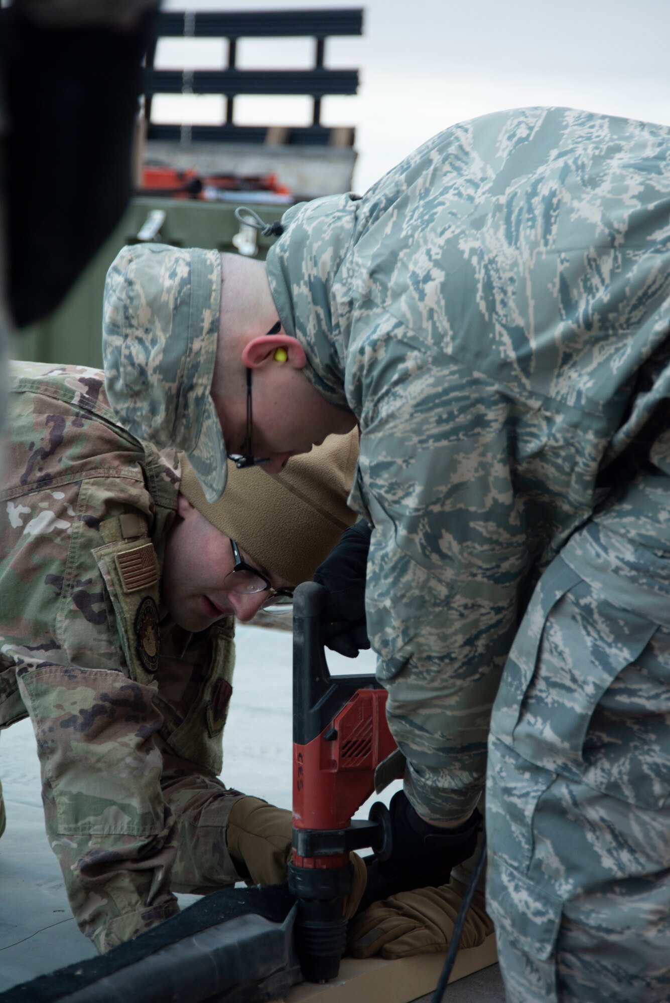 U.S. Air Force Staff Sgt. Jonathan Walters, 366th Civil Engineering Squadron water and fuel systems maintenance journeyman, assists Airman Kain Mardlin, 366th Operation Support Squadron air traffic controller, with using construction tools to build a tent, Jan. 23, 2020, on Mountain Home Air Force Base, Idaho. The Base Emergency Engineer Force training tests Airmen’s ability to work together with Airmen from different squadrons. (U.S. Air Force photo by Airman 1st Class Akeem K. Campbell)