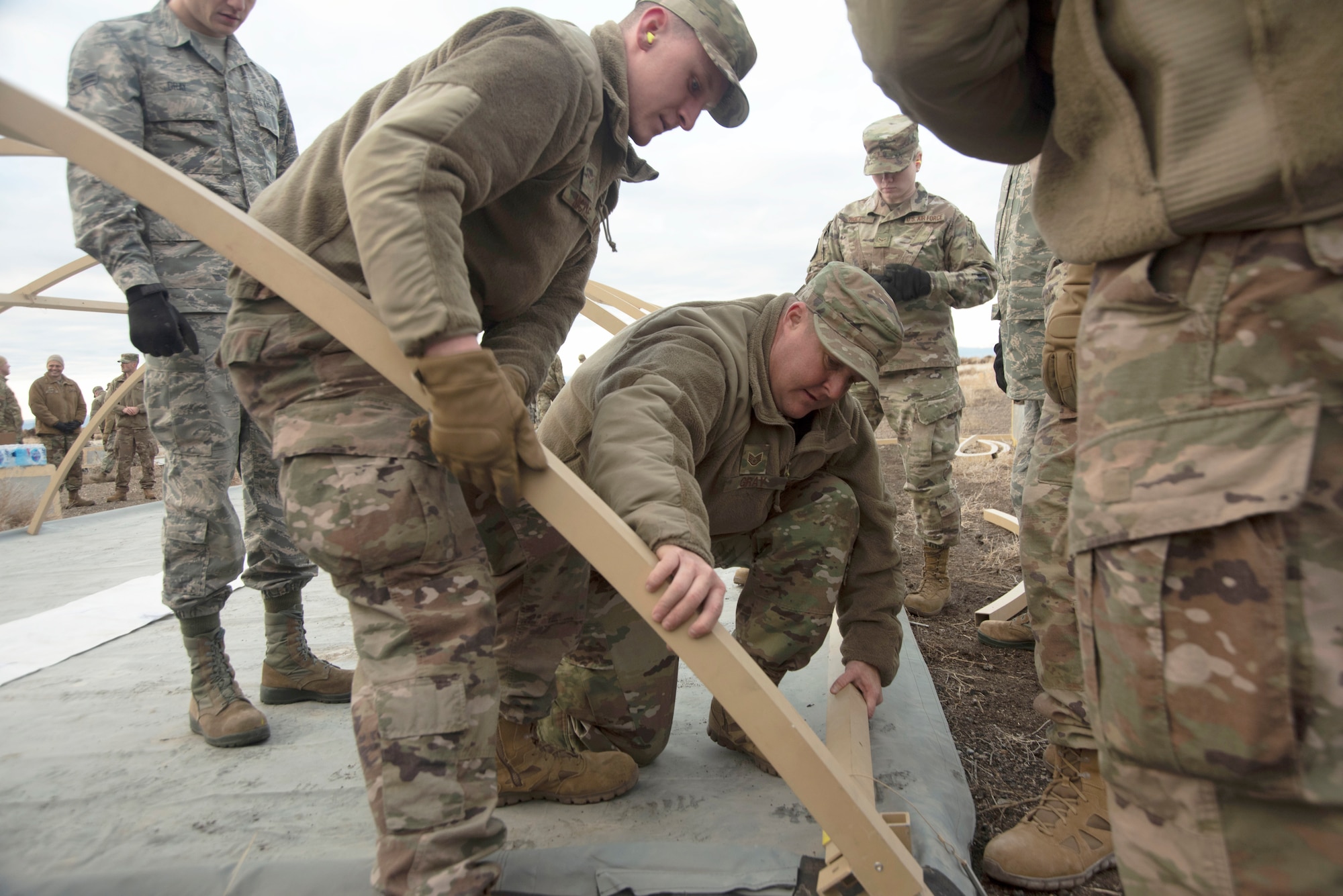 U.S. Air Force Staff Sgt. James Gray, 366th Civil Engineering Squadron structural craftsman, assists his group with building a tent, Jan. 23, 2020, on Mountain Home Air Force Base, Idaho. This training prepares Airmen for obstacles in future deployments. (U.S. Air Force photo by Airman 1st Class Akeem K. Campbell)