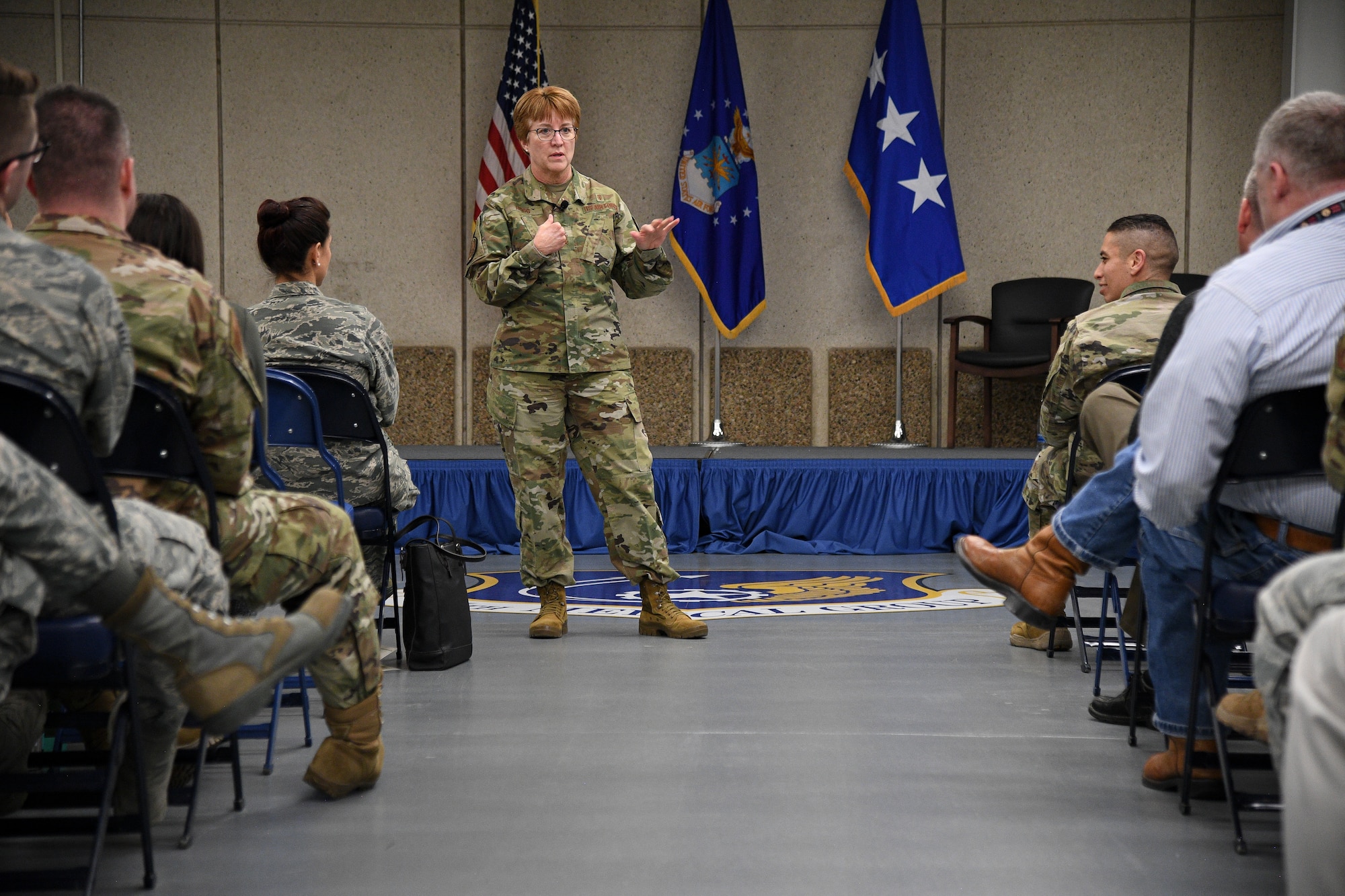 Lt. Gen. Dorthy A Hogg stands in the aisle during a town hall meeting to address Hill AFB's military, civilian and contractor  medical personnel.