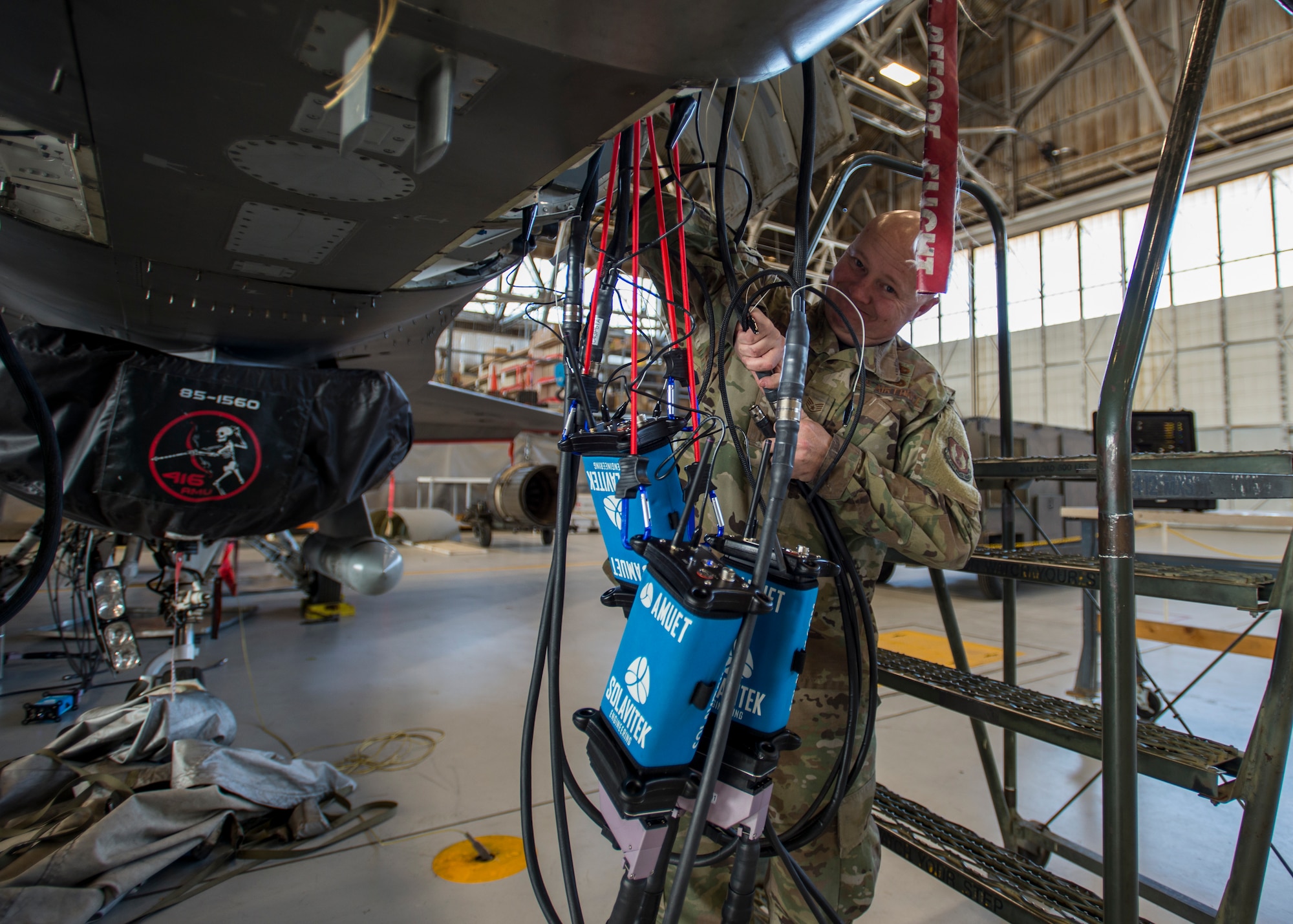 Staff Sgt. Jocko Hammond, 412th Aircraft Maintenance Squadron, attaches a wire bundle to an Advanced Mobile Universal Electrical Tester, or AMUET, at Edwards Air Force Base, California, Feb. 4. (Photo by Giancarlo Casem)