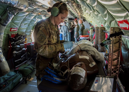 U.S. Air Force 1st Lt. Elayne Smith, 43rd Aeromedical Evacuation Squadron flight nurse, places electrocardiogram leads onto a training mannequin during an aeromedical evacuation training mission at Travis Air Force Base, California, Feb. 11, 2020. The 43rd AES is currently transitioning from its present station at Pope Army Airfield, North Carolina, to become part of the 60th AES at Travis Air Force Base, California, providing more training opportunities on the KC-10 Extender, C-5 Super Galaxy and C-17 Globemaster III based there, as well as KC-135s based out of Fairchild. (U.S. Air Force photo by Senior Airman Lawrence Sena)