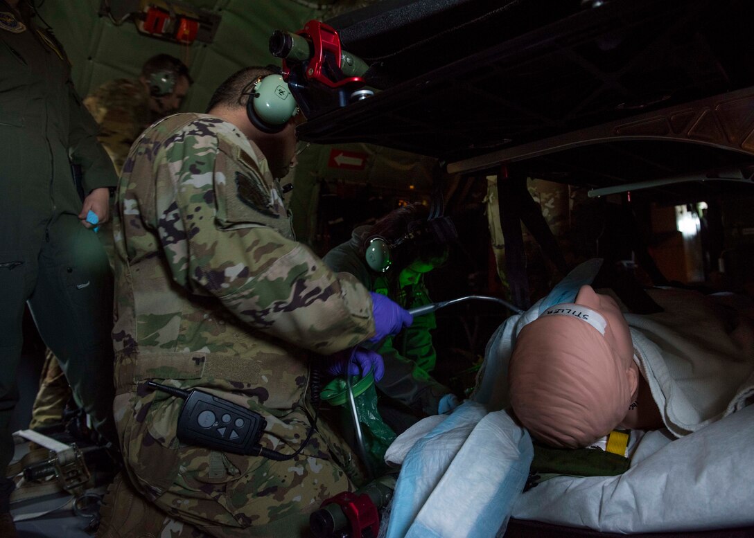 U.S. Air Force Lt. Col. David Hernandez (left), 43rd Aeromedical Evacuation Squadron chief flight nurse, and Tech. Sgt. Rachel Selph, 43rd AES aeromedical evacuation technician, perform a simulated in-flight medical emergency response on a Fairchild Air Force Base KC-135 Stratotanker during an aeromedical evacuation mission at Travis Air Force Base, California, Feb. 11, 2020. Team Fairchild is able to strengthen their partnership with the 43rd AES by supporting their aeromedical evacuation training alongside mobility teammates at Travis Air Force Base, helping to build a modern mobility force that will ensure the delivery of strength and hope now and in the future. (U.S. Air Force photo by Senior Airman Lawrence Sena)