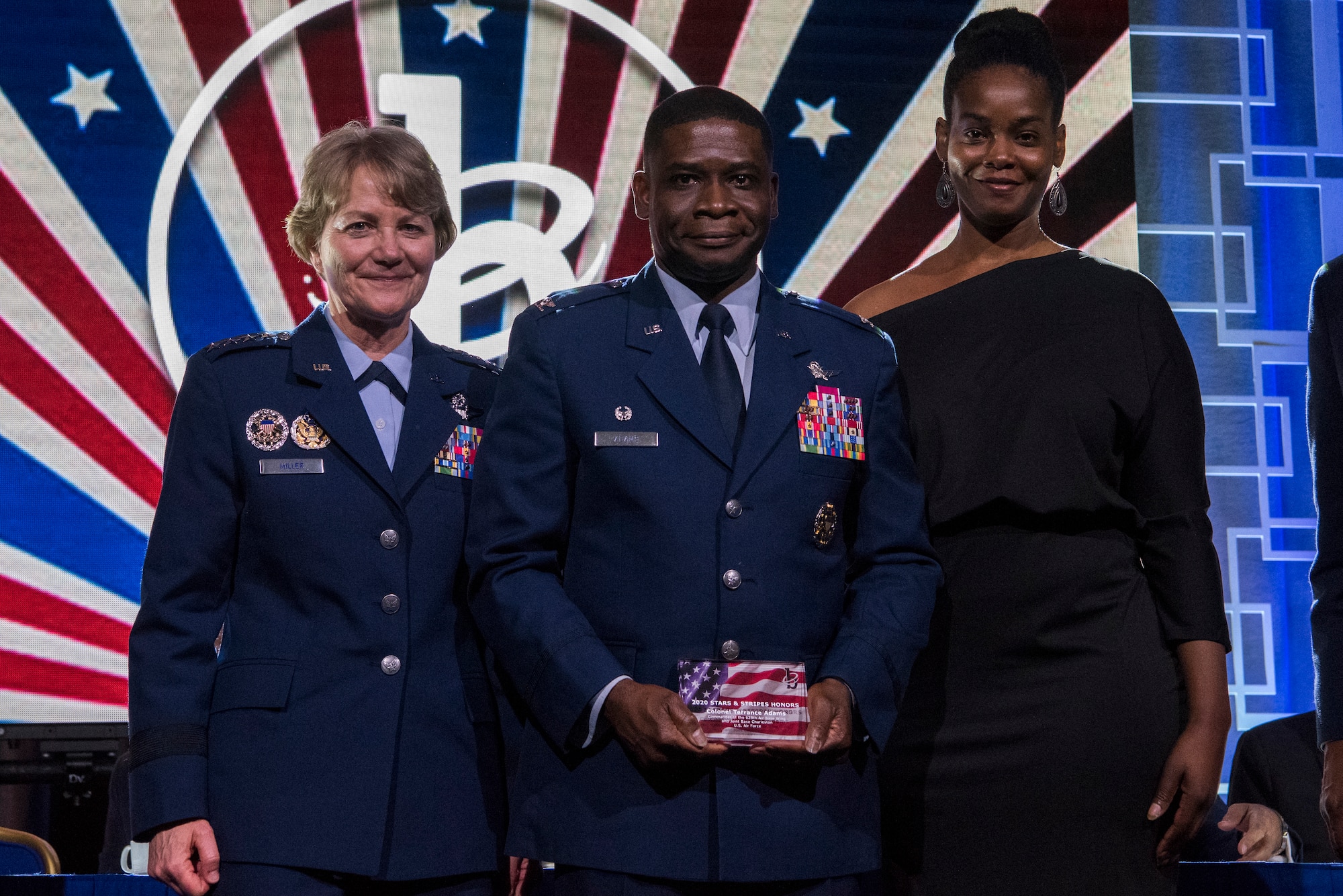 Col. Terrance A. Adams, commander of the 628th Air Base Wing and Joint Base Charleston, S.C., along with his sister, Felicia Johnson, accepted the Military Service Award from Gen. Maryanne Miller, Air Mobility Command commander, at the 2020 Black Engineer of the Year Stars and Stripes dinner, Feb. 14, 2020, Washington, D.C. Adams earned the award for his more than 14 years of service to BEYA and over 5,000 students reached. (U.S. Air Force photo by Staff Sgt. James Richardson)
