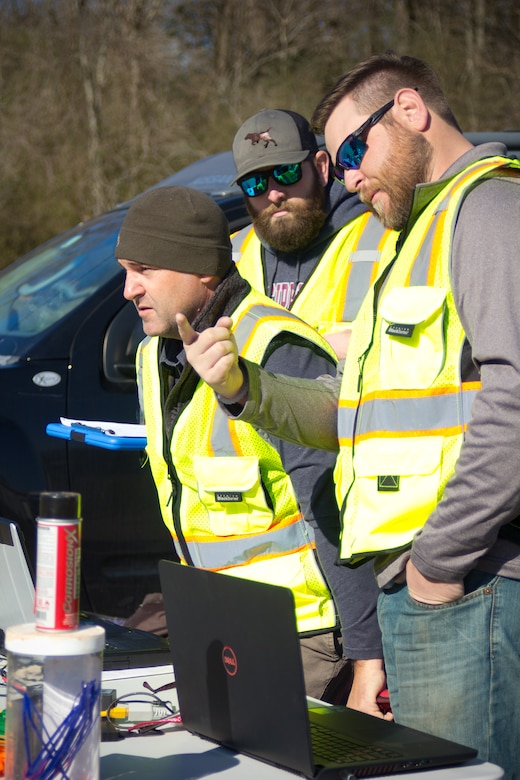 The U.S. Army Engineer Research and Development Center-Environmental Laboratory’s Unmanned Aircraft Systems team members Barry Barnett, Kenneth Matheson and Shea Hammond watch the Vapor 55, a UAS that weighs just under 55 pounds and carries both the LiDAR sensor and 42MP camera, as it follows its flight path around the installation.