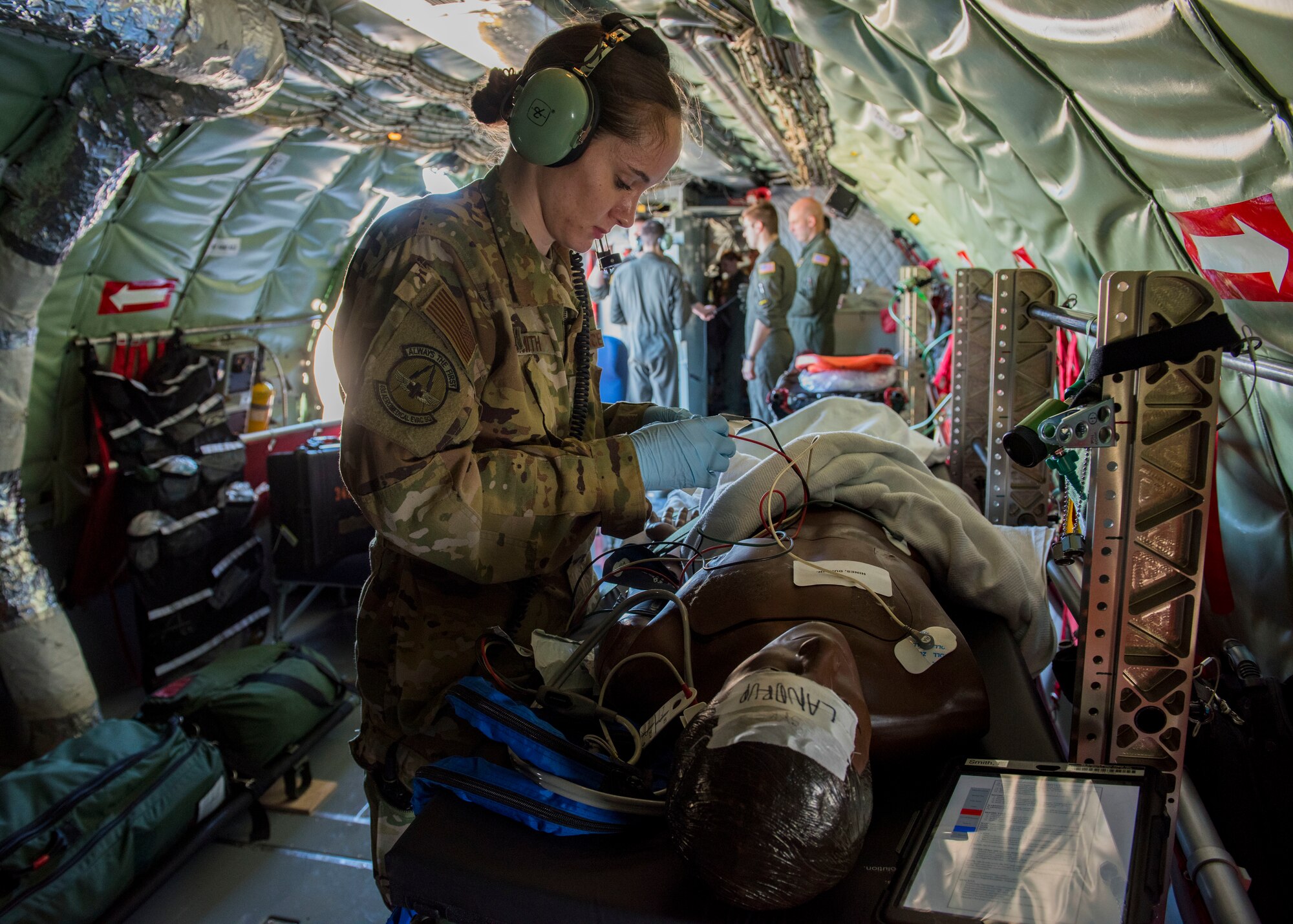 U.S. Air Force 1st Lt. Elayne Smith, 43rd Aeromedical Evacuation Squadron flight nurse, places electrocardiogram leads onto a training mannequin during an aeromedical evacuation training mission at Travis Air Force Base, California, Feb. 11, 2020. The 43rd AES is currently transitioning from its present station at Pope Army Airfield, North Carolina, to become part of the 60th AES at Travis Air Force Base, California, providing more training opportunities on the KC-10 Extender, C-5 Super Galaxy and C-17 Globemaster III based there, as well as KC-135s based out of Fairchild. (U.S. Air Force photo by Senior Airman Lawrence Sena)