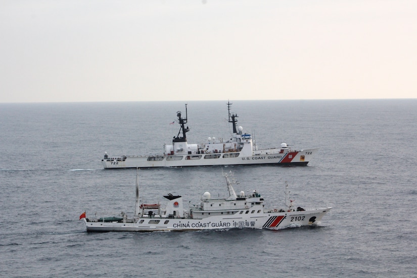 The Coast Guard Cutter Morgenthau and China coast guard vessel 2102 steam alongside each other during the transfer of the fishing vessel Yin Yuan in the North Pacific Ocean June 3, 2014.