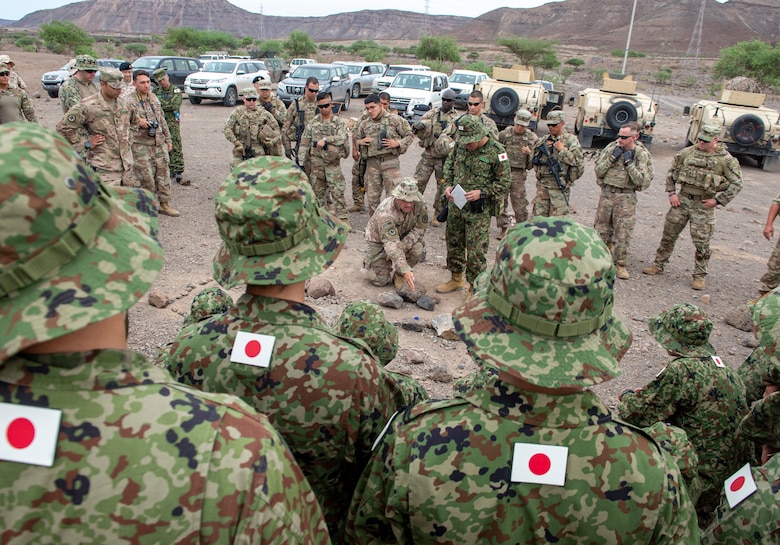 US Army 1LT Nicholas Sereday, executive officer for Charlie Company 2-113th Infantry assigned to Combined Joint Task Force-Horn of Africa, gives a concept of operations brief to Japanese and US military forces during a bilateral field training exercise in Djibouti, Africa, 2 October 2019.