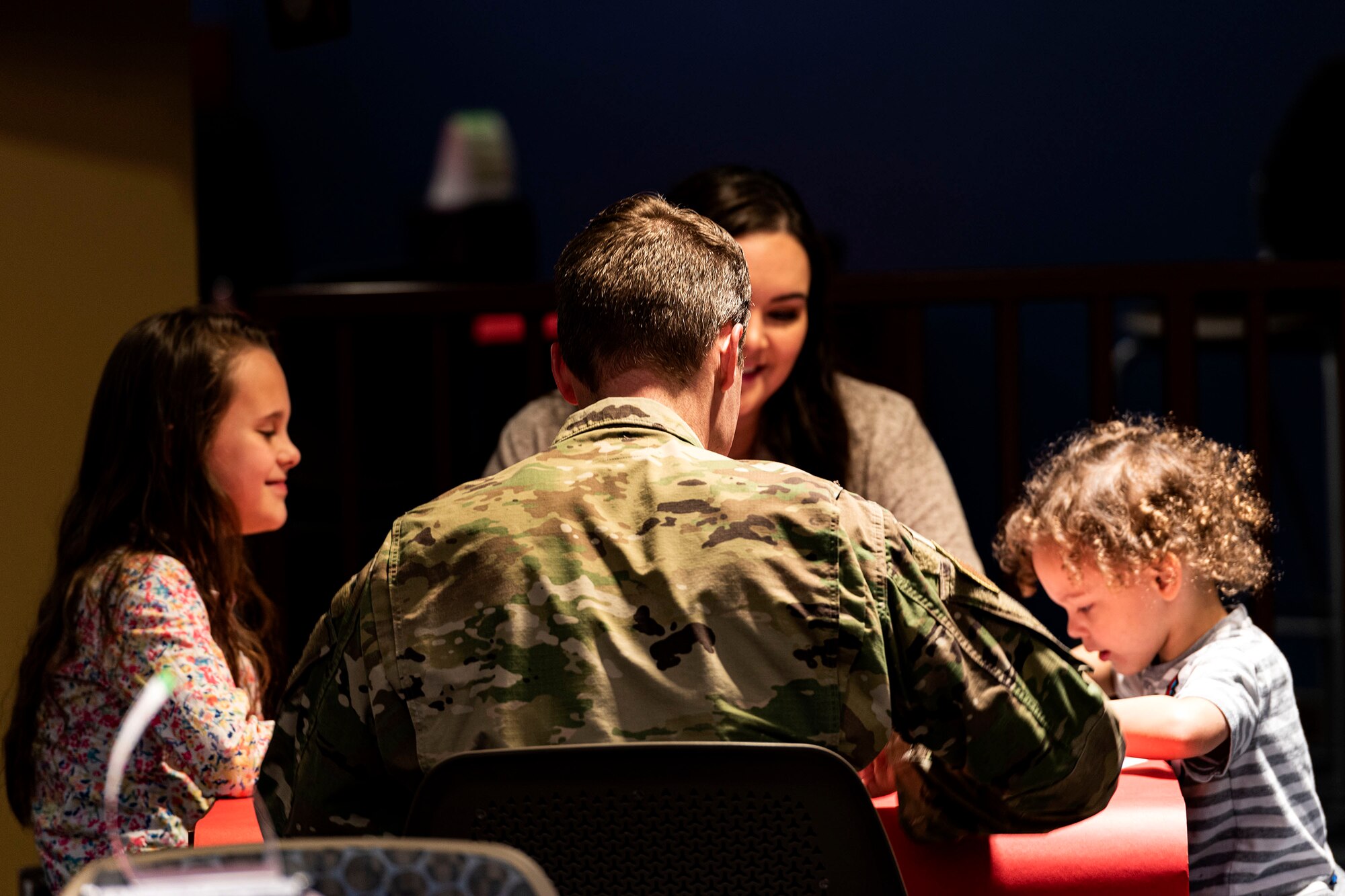 Photo of an Airmen speaking with a family.