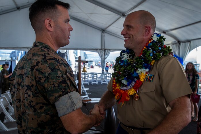 U.S. Marine Corps Sgt. Maj. Charles Well, sergeant major, Marine Corps Base Hawaii, shakes Lt. Col. William Smith's hand during Smith's retirement ceremony, Joint Base Pearl Harbor-Hickam, Feb. 14, 2020. Smith retired from the Marine Corps after 21 years of honorable and faithful service. (U.S. Marine Corps photo by Cpl. Matthew Kirk)