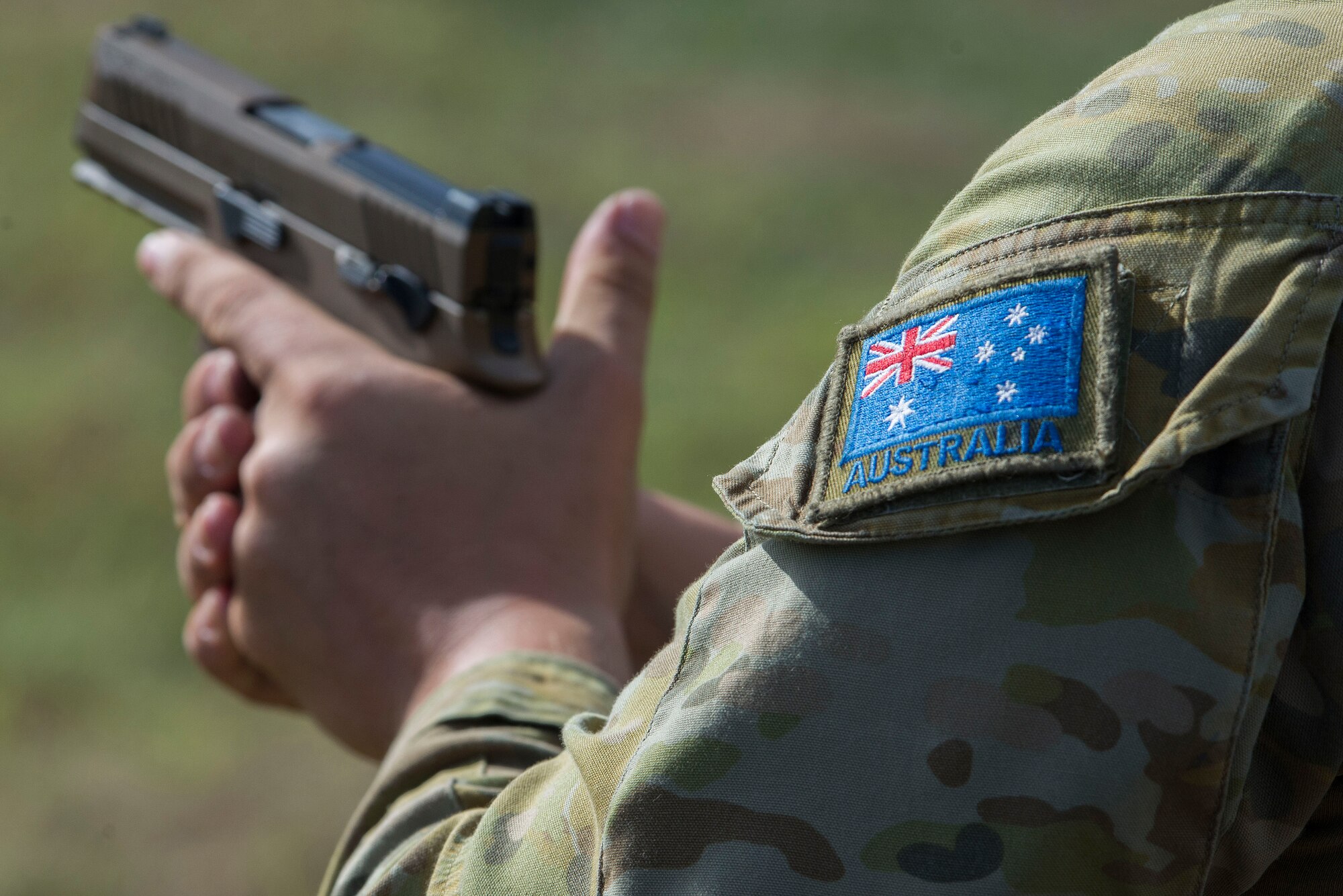 A member of the Royal Australian Air Force (RAAF) prepares to shoot a U.S. Air Force M18 pistol during Pacific Defender 20-1 at Andersen Air Force Base, Guam, Feb. 12, 2020.