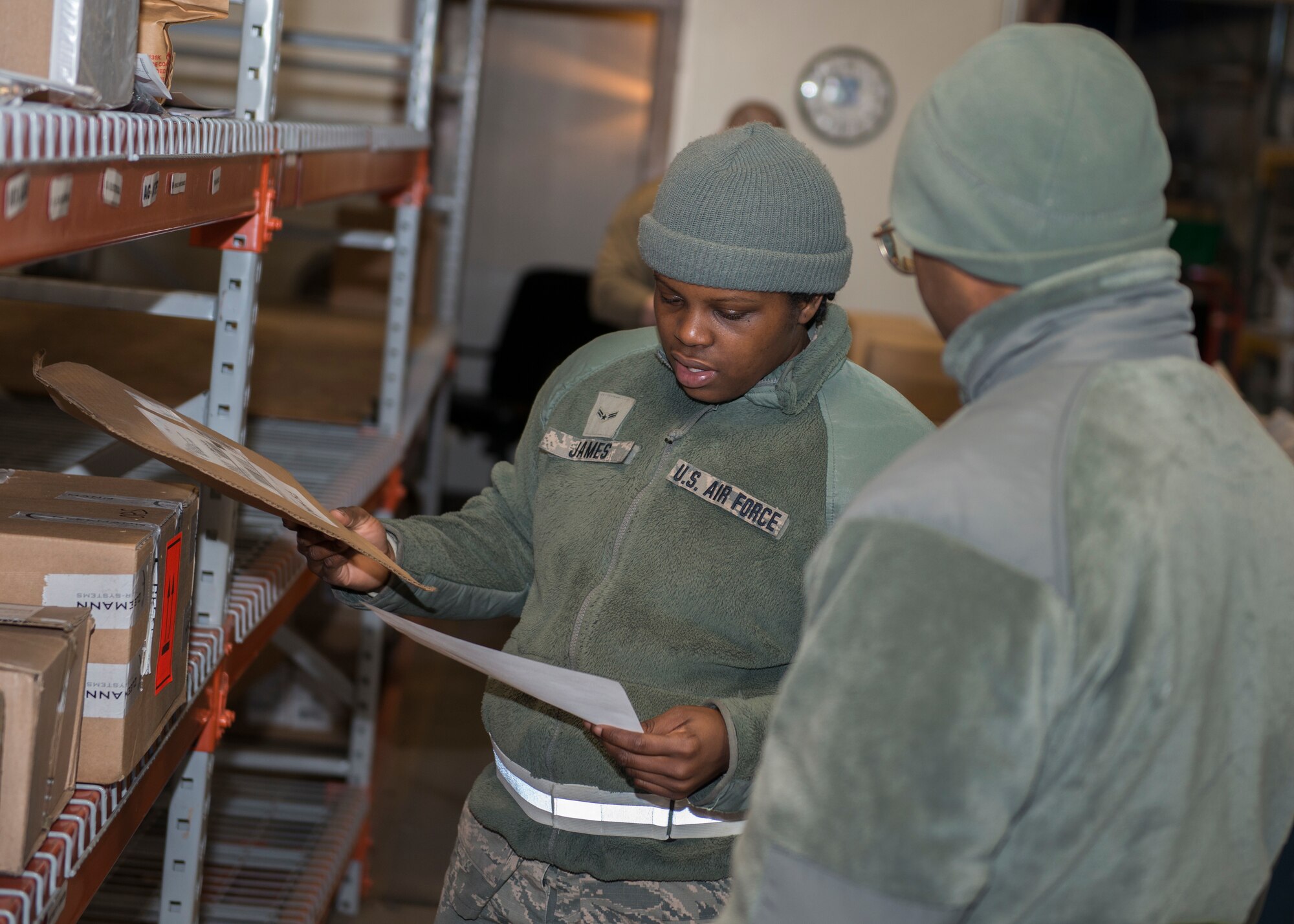 Airman 1st Class Zainab James (left) and Airman Basic Andre Minnis, 103rd Logistics Readiness Squadron ground transportation specialists, prepare deliveries to organizations at Bradley Air National Guard Base, East Granby, Conn. Feb. 8, 2020. The Traffic Management Office delivers incoming equipment to organizations throughout the installation and prepares outgoing shipments. (U.S. Air National Guard photo by Staff Sgt. Steven Tucker)