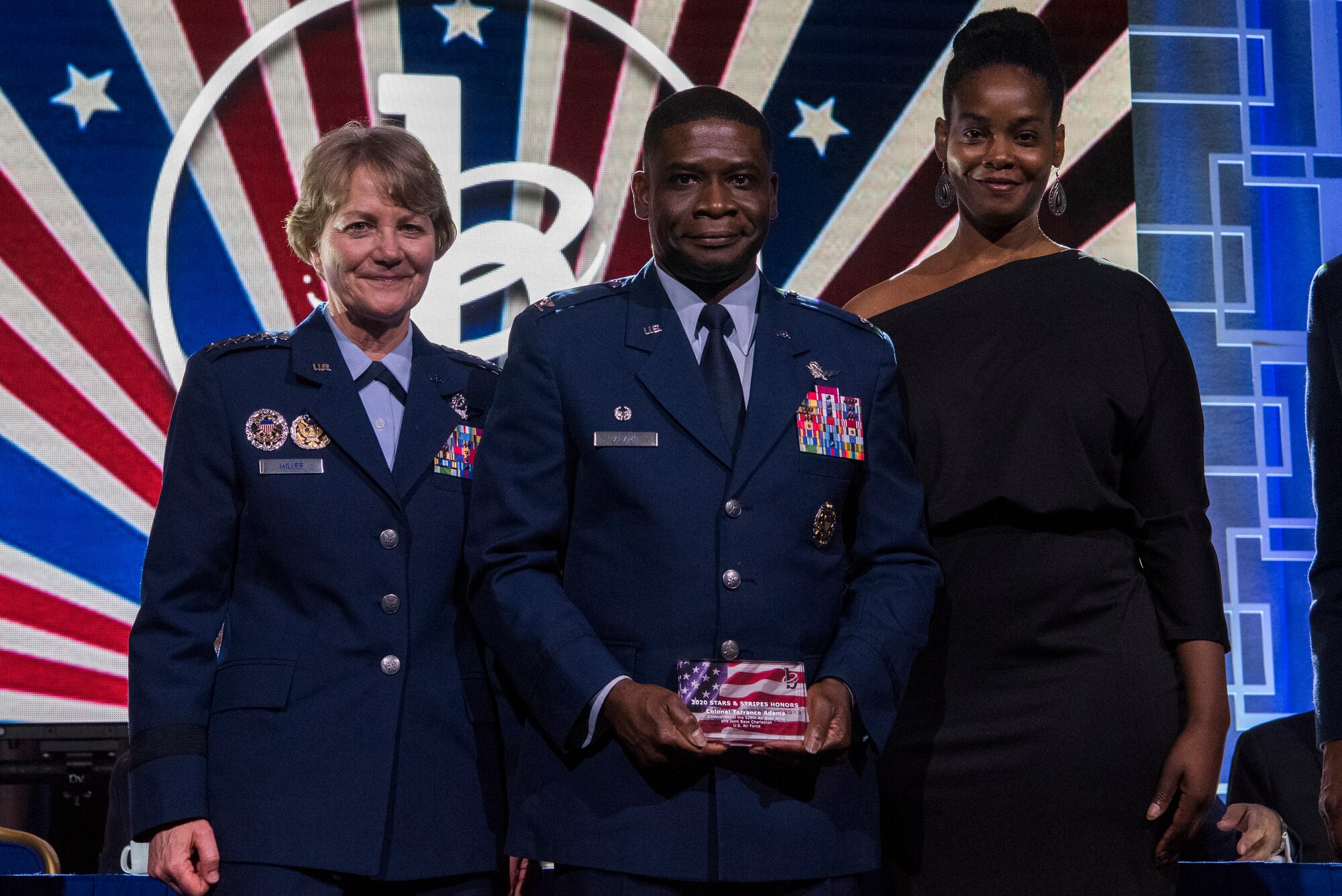 Col. Terrance A. Adams, commander of the 628th Air Base Wing and Joint Base Charleston, S.C., along with his sister, Felicia Johnson, accepted the Military Service Award from Gen. Maryanne Miller, Air Mobility Command commander, at the 2020 Black Engineer of the Year Stars and Stripes dinner, Feb. 14, 2020, Washington, D.C. Adams earned the award for his more than 14 years of service to BEYA and over 5,000 students reached. (U.S. Air Force photo by Staff Sgt. James Richardson)