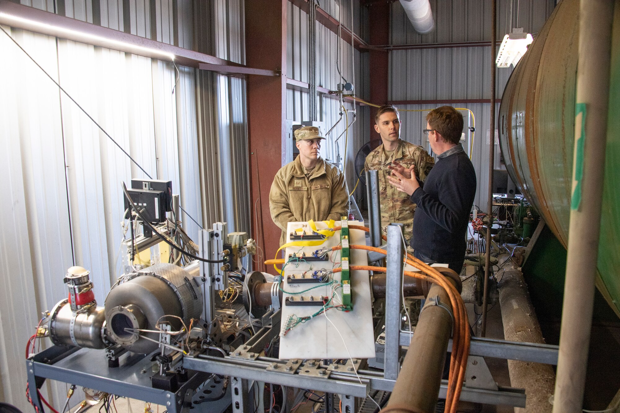 Tech. Sgt. Anthony Bennett and 1st Lt. Jack Robinson, both with the 821st Contingency Response Support Squadron, discuss the capabilities of a mobile power generator with Greg Thomas, Scaled Power lead propulsion engineer, during a demonstration at Scaled Power’s test facility in San Francisco, California, Feb. 3, 2020. In its continuing effort to become more light, lean and lethal, Airmen from the 821st Contingency Response Group assigned to Travis Air Force Base in California, continue to advance the concept of a smaller power generator, with the capability to support contingency response missions and Joint Services across the entire Global Air Distribution Network. (U.S. Air Force photo by Tech. Sgt. Liliana Moreno)