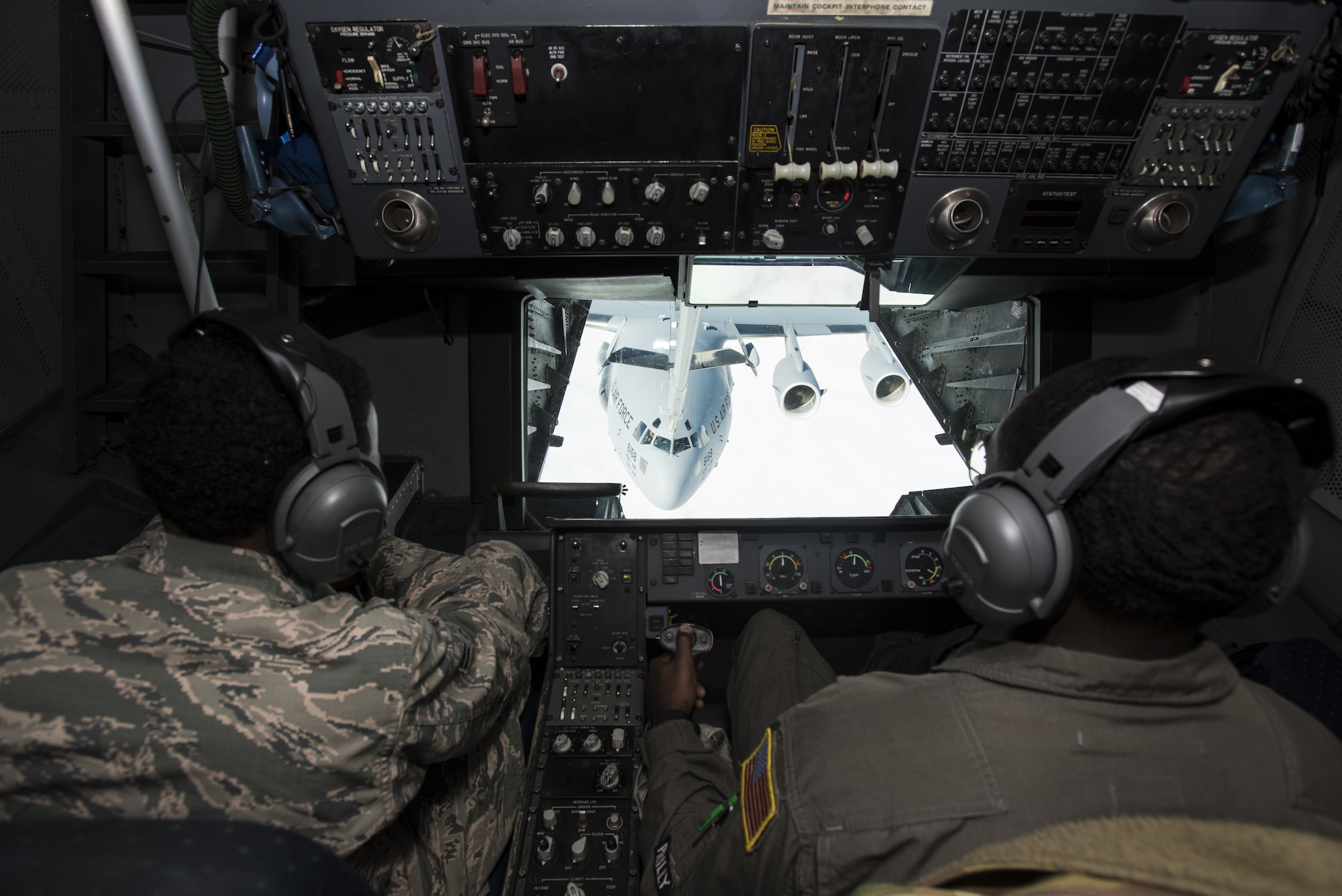 Airman 1st Class Shareik Griffin, 605th Aircraft Maintenance Squadron crew chief, and Senior Airman Kwame Ansah, 32nd Air Refueling Squadron boom operator, sit in the boom operator box of a KC-10 Extender assigned to Joint Base McGuire-Dix-Lakehurst, New Jersey, during a Black History Month heritage air-refueling flight over the East Coast, Feb. 13, 2020. The purpose of the heritage flight was to showcase the accomplishments African-American have made in the U.S. Air Force and inspire others, not just African-Americans, to reach for what they may think is impossible. (U.S. Air Force photo by Senior Airman Ariel Owings)