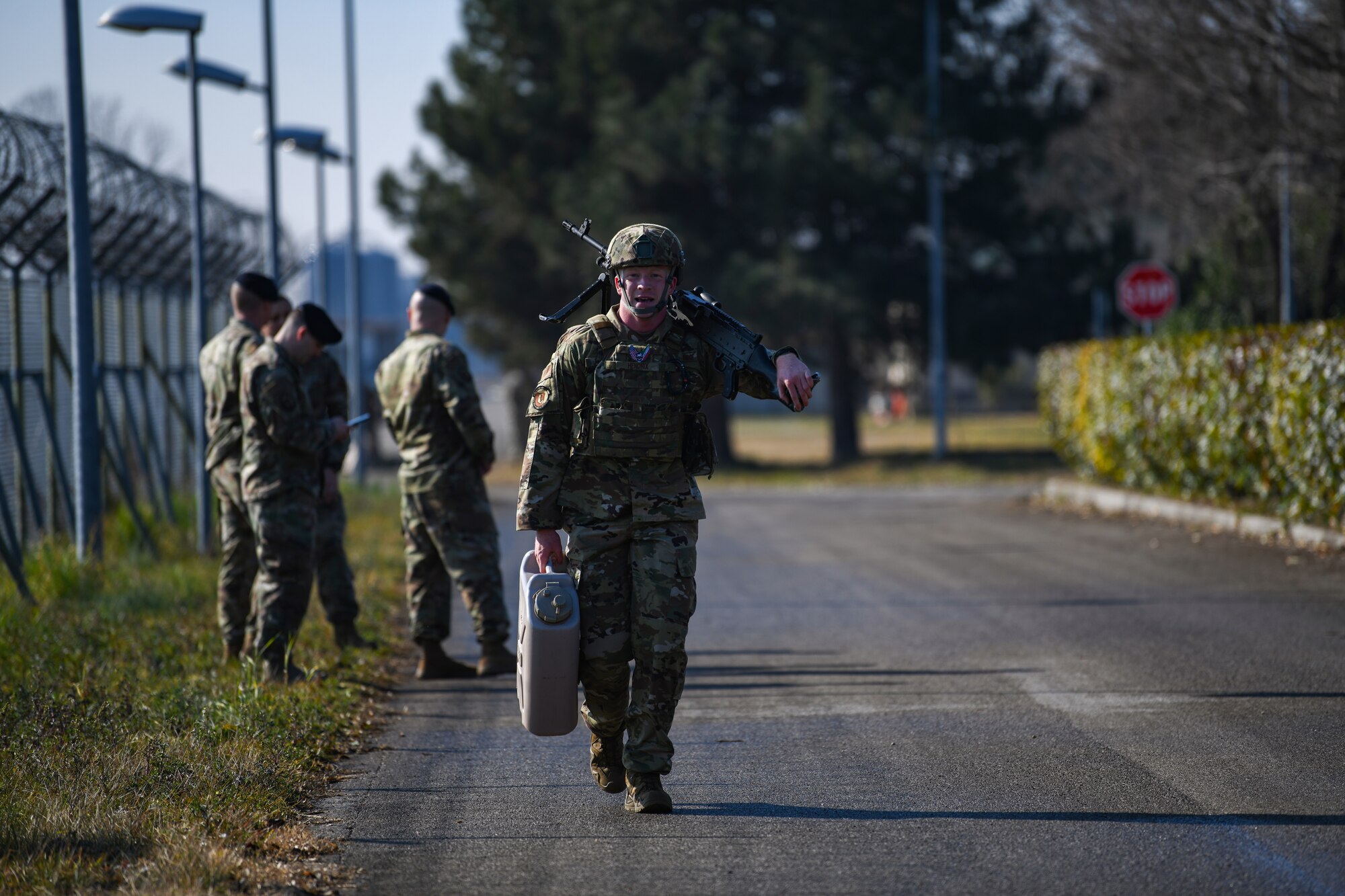 U.S. Air Force Airman 1st Class Hunter B. Hendrix, 31st Security Forces Squadron member, carries one jerry can, and an M240 machine gun at Aviano Air Base, Italy, Feb. 14, 2020. Airmen participated in a 400 meter equipment carry during the three day Defender Challenge. (U.S. Air Force photo by Airman 1st Class Ericka A. Woolever)
