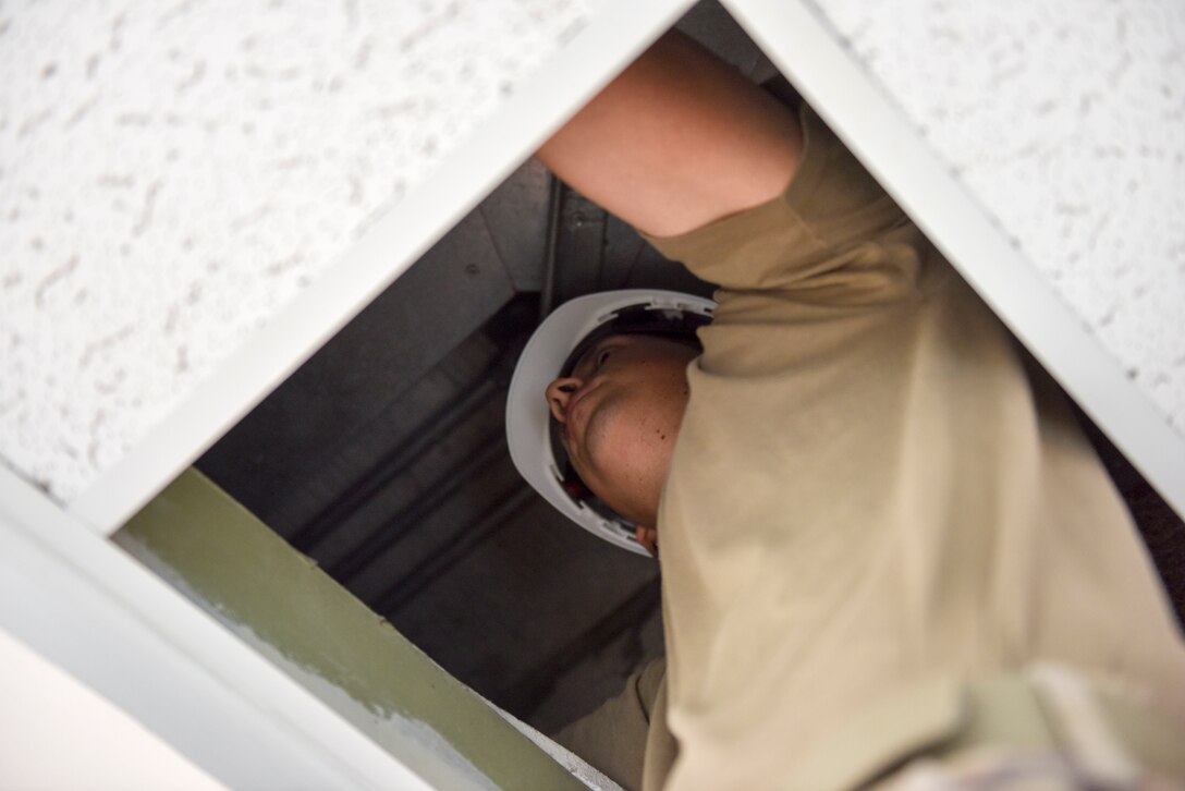 Staff Sgt. Rubin Chavez, 379th Expeditionary Communications Squadron cable and antenna systems supervisor, runs a cable for a mass announcement system at Al Udeid Air Base, Qatar on Feb. 19, 2020. The mass announcement system will be installed in buildings across the installation, enabling more effective communication during emergencies, increasing safety and readiness for personnel at AUAB. (U.S. Air Force photo by Tech. Sgt. John Wilkes)