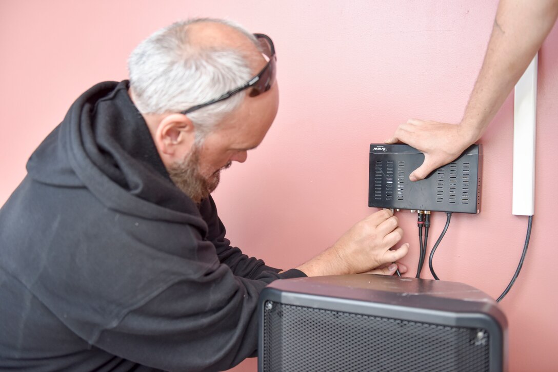 Stephen Howard, 379th Expeditionary Communications Squadron cable TV technician, runs a cable for a mass announcement system at Al Udeid Air Base, Qatar on Feb. 19, 2020. The mass announcement system will be installed in buildings across the installation, enabling more effective communication during emergencies, increasing safety and readiness for personnel at AUAB. (U.S. Air Force photo by Tech. Sgt. John Wilkes)