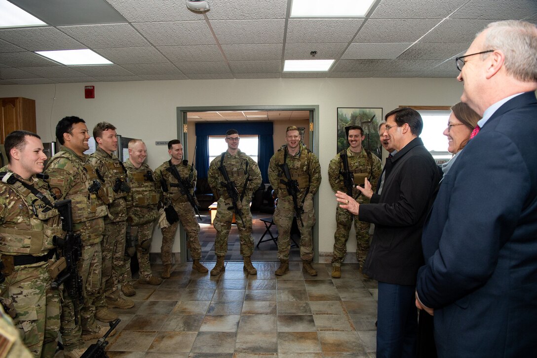 Defense Secretary Dr. Mark T. Esper speaks to airmen in a large room.