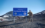 Master Sgt. Justin Rogers, occupational safety specialist, 108th Wing, New Jersey Air National Guard, stands near the marker of McMurdo Station, Antarctica, Nov. 8, 2019. Rogers backfilled as the 109th safety manager while at McMurdo Station.