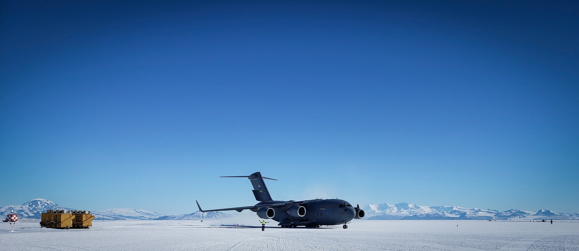 Master Sgt. Justin Rogers, occupational safety specialist, 108th Wing, New Jersey Air National Guard, watches as a C-17 Globemaster arrives at McMurdo Station, Antarctica, Nov. 15, 2019.