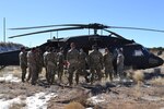 New Mexico National Guard medics learn how to prepare and load patients for medical evacuation in Rio Rancho Feb. 13, 2020.