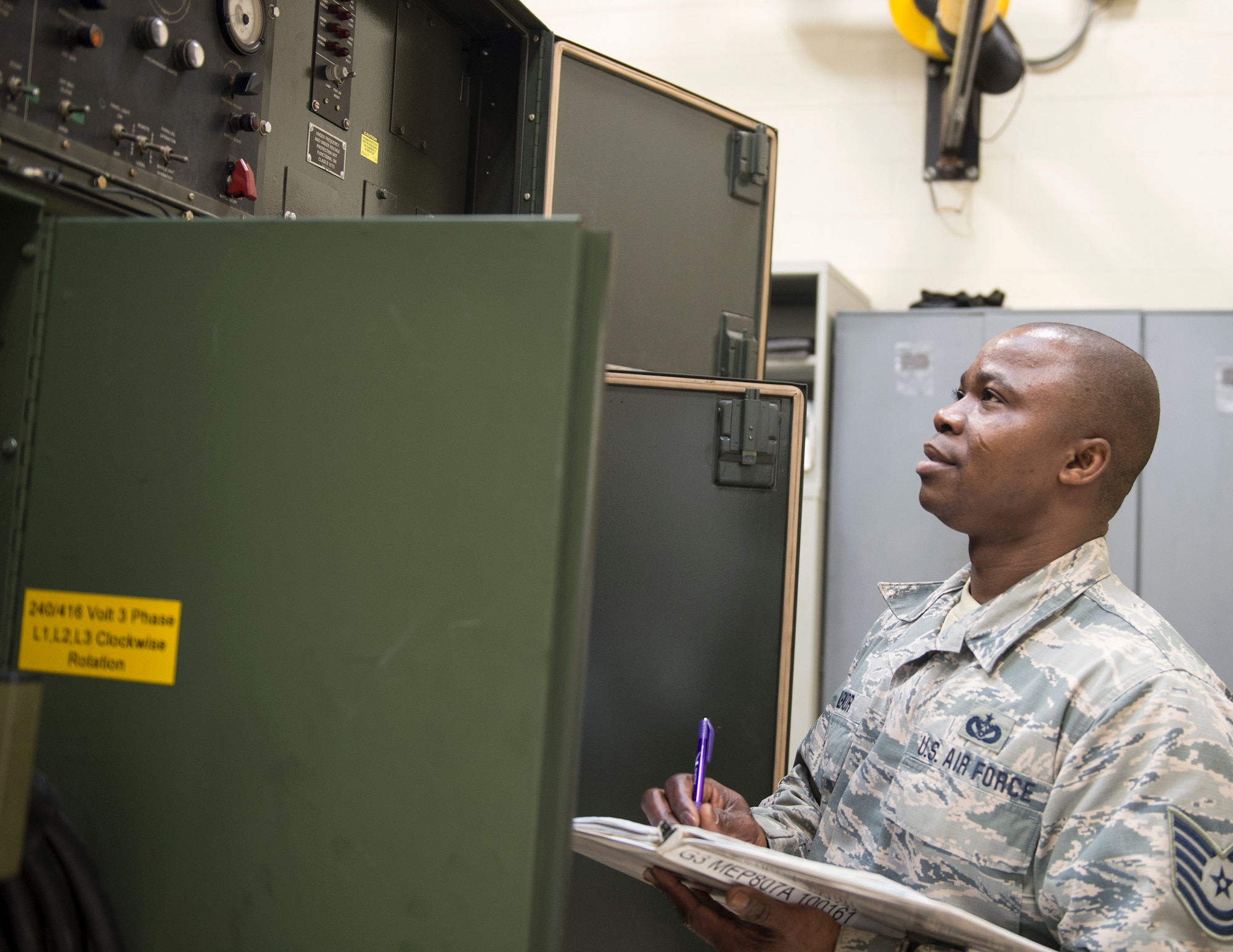 U.S. Air Force Tech. Sgt. Kokou Azalekor, an electrical power production technician with the 133rd Civil Engineer Squadron, records information onto a generator log in St. Paul, Minn., Feb. 12, 2020.