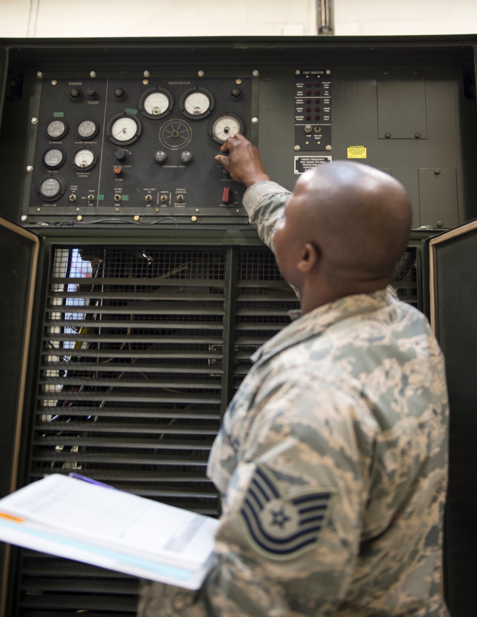 U.S. Air Force Tech. Sgt. Kokou Azalekor, an electrical power production technician with the 133rd Civil Engineer Squadron, adds oil to MEP 009B generator in St. Paul, Minn., Feb. 12, 2020.