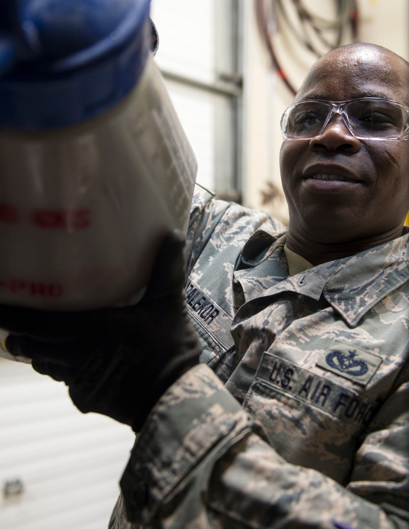 U.S. Air Force Tech. Sgt. Kokou Azalekor, an electrical power production technician with the 133rd Civil Engineer Squadron, adds oil to MEP 009B generator in St. Paul, Minn., Feb. 12, 2020.