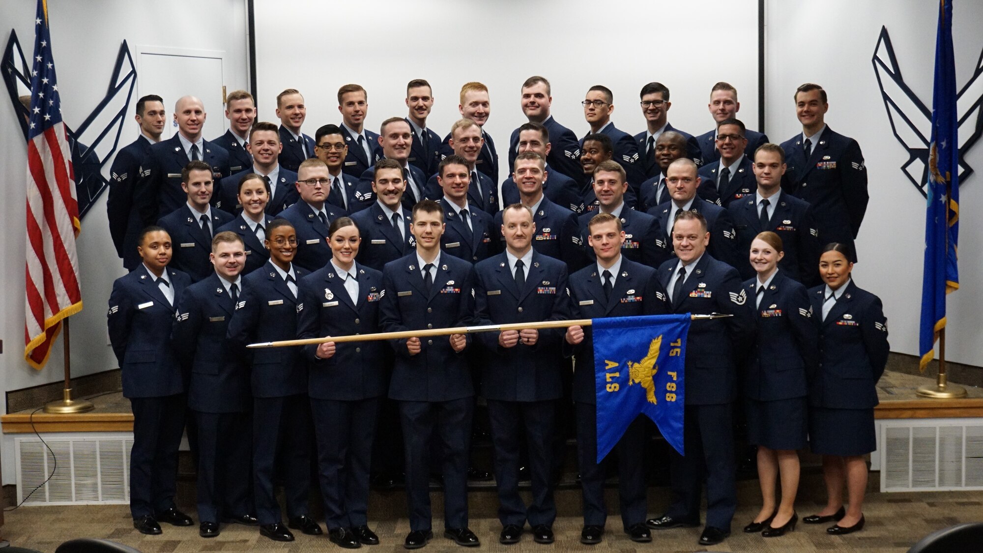 The graduates of Airman Leadership Class 20-B pose for a group photo.