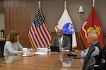 Leaders discuss Troop Support mission around the table.